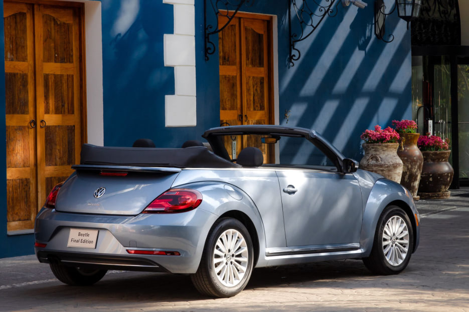 A Beetle convertible parked in a trendy neighborhood